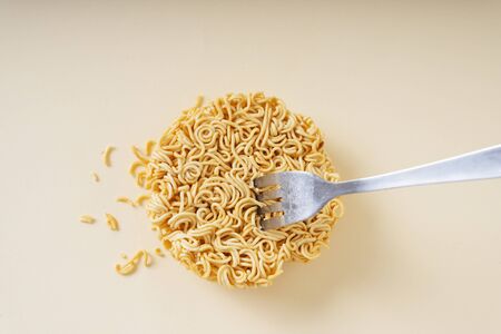Circle shape of Instant noodle and fork stick on it.の写真素材