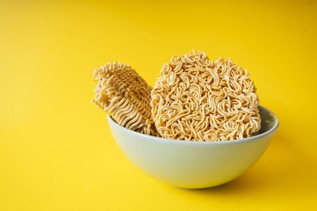 Group of Instant noodles in the bowl on yellow background.の写真素材