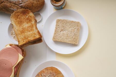Bread fast concept - Bread with hamd and cheese also jam on a plate.