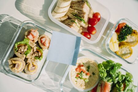 Food delivery concept. Copy space. Healthy food salad bowl and spring roll also sandwich on table.の写真素材