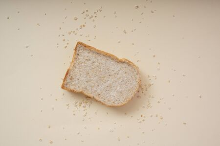 Top view of sliced bread over beige background.