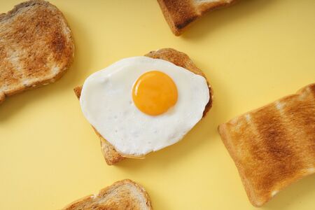 Top view - Grilled home made organic sliced bread with fried egg on top.