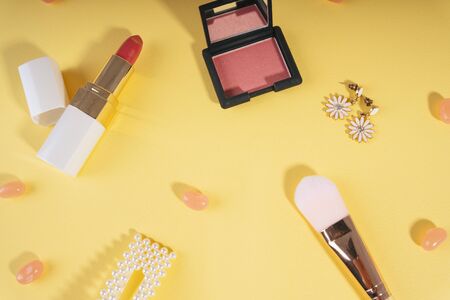 Woman accessories cosmetic background on yellow background.の写真素材