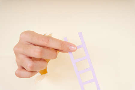 Woman hand pick up ladder isolate over white warm background.の写真素材