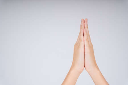 Woman hand praying symbol hold hand together. Pray and gratitude. Hello, Thank you, and good bye in Thai meaning.の写真素材