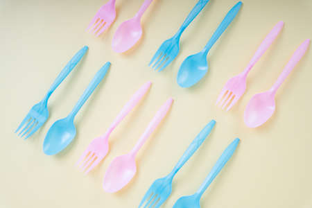 Colourful pastel utensil spoon and fork over bright yellow background.の写真素材