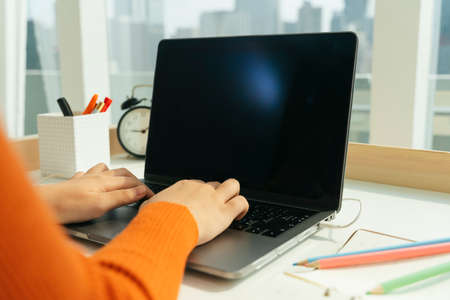 Student stuck at home because of Covid-19. Girl studying or learning from home with laptop.
