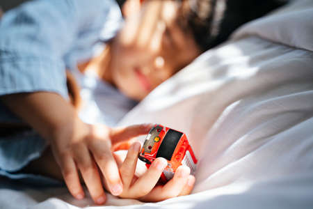 Cropped image of car toy in the boy's hands that he hold while sleeping at the noon.