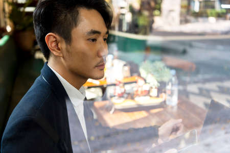 Asian businessman on white shirt interviewing candidate with laptop.