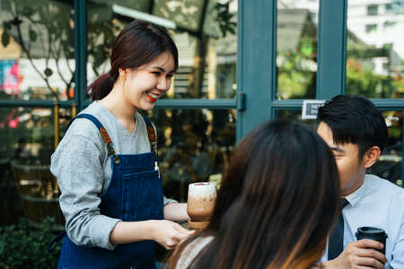 Young asian business people talking about business, looking at presentation on laptop.の写真素材