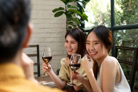 Group of young asian thai people enjoy drinking red wine toasting and celebrating.の写真素材