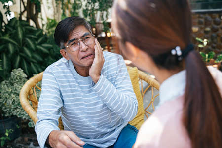 Private duty nurse explain the result of observation for her old patient in the backyard of his house.の写真素材