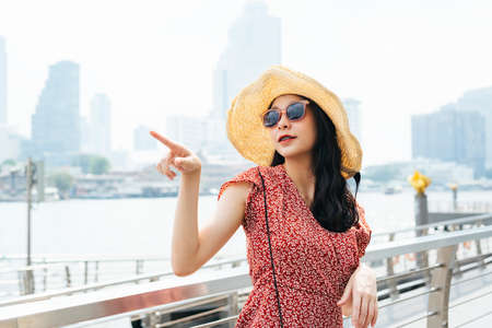 Cheerful asian woman sitting at front seat in the car - Copy space.の写真素材