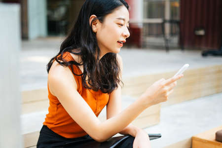 young beautiful Thai asian traveler woman wearing red dress cover her mouth during smog crisis in...