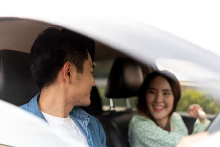 Beautiful asian thai woman traveling in the car with her friend.の写真素材