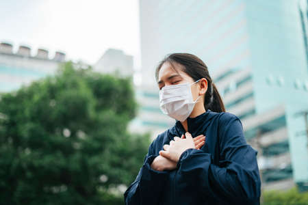 Asian woman with crying posture walking in the city.の写真素材
