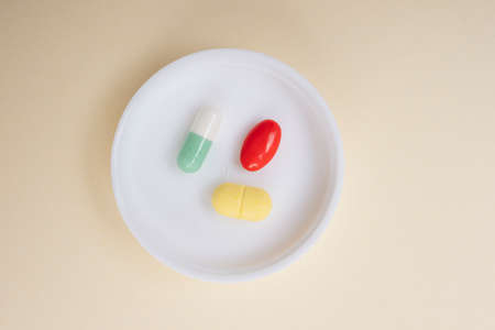 Three difference medicine pill capsule on white lid.の写真素材