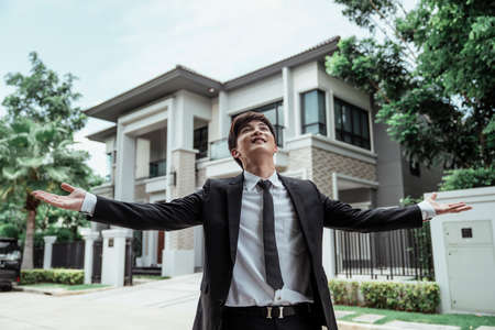 Smart asian businessman on white casual dress talking on the phone at home or resort or hotel.の写真素材