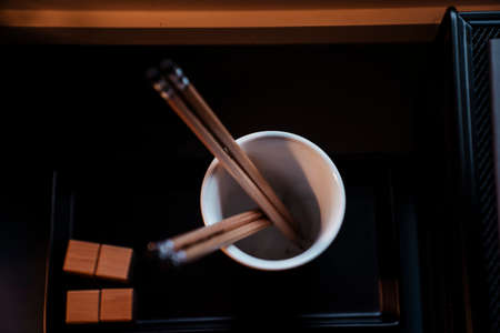 Top view - Wooden pencils in a cup on working desk.の写真素材