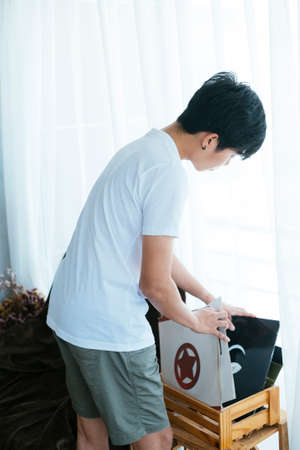 Black hair musician guy find the vinyl in his wooden box.