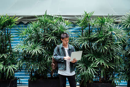 short hair guy open laptop to revise the project for his client after he sudenly get the new comment...