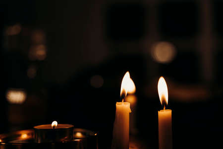 Candles light burning at night in the dark room.