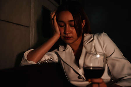 Drunk business woman fall asleep after drinking red wine too much.