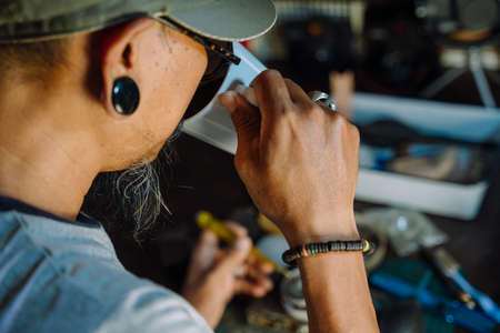 A man fix the film camera and clean the dust on the lens then assemble all the part together.の写真素材