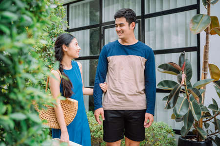 Asian thai couple tourist in casual shirt going for shopping together in city street.