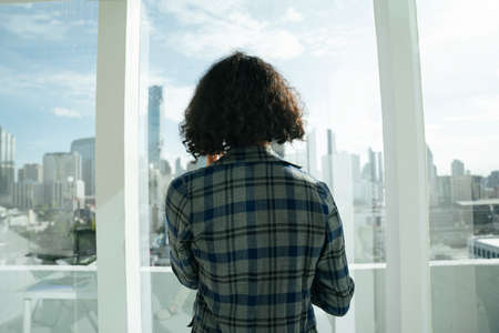 Back view - African curly hairstyle woman looking at Bangkok city.の写真素材