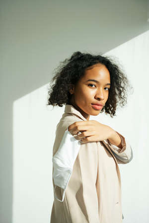 Portrait of african curly hairstyle woman holding a mask for mock up.