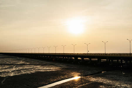 Sunset view on highway road over sea bridge in Thailand. silhouette shot.の写真素材