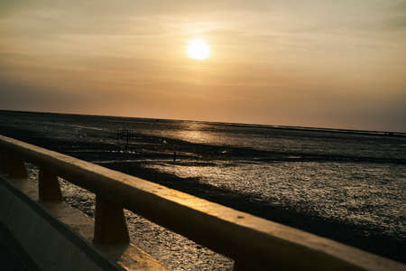 Sunset view on highway road over sea bridge in Thailand. silhouette shot.の写真素材