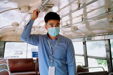 Asian business man go to work by a bus transportation.の写真素材