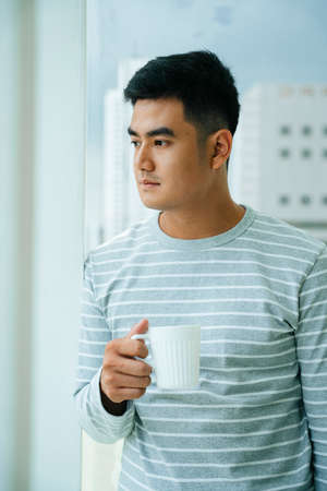 Adult asian man enjoy hot coffee in the morning.