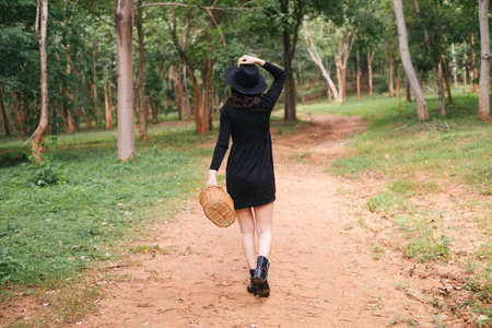 Black witch walking back after finish her herb's finding.の写真素材