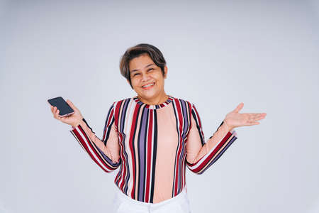 Portrait of cheerful happy old elderly senior woman with smartphone.