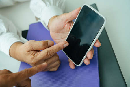 Couple old people using smartphone for shopping, ordering, and booking.の写真素材