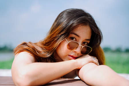 Beautiful asian woman traveler dark hair and wear eyeglasses outdoors.の写真素材