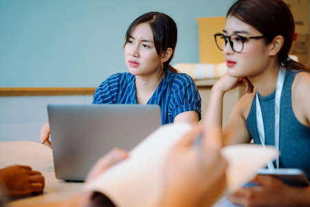 Two asian business women working together with customer in conference room.の写真素材
