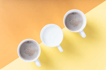 Top view - Three cups of different kind of coffee on color background.の写真素材