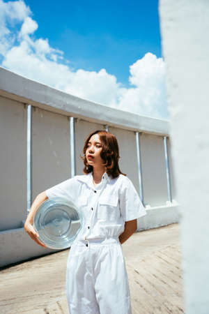 Asian woman took off glass bowl pretend to be astronaut on earth.