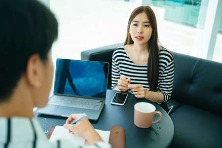 Journalist making interview with beautiful influencer for blog writing.