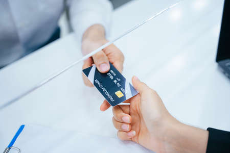 Close up hands customer paying for cost with credit card.の写真素材