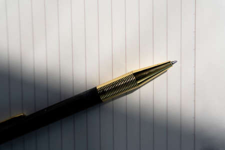 Blank open book with golden pen - flat lay.の写真素材