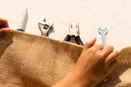 Hand of engineer cleaning and keeping tools with cloth.の写真素材