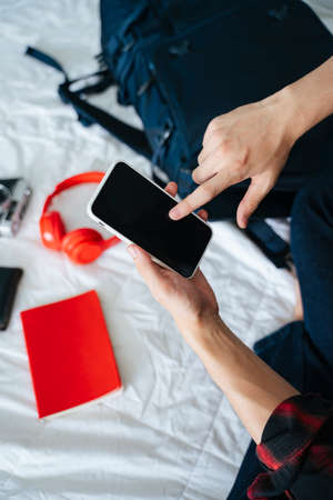 Asian young man looking at map on digital smartphone for travel trip.の写真素材