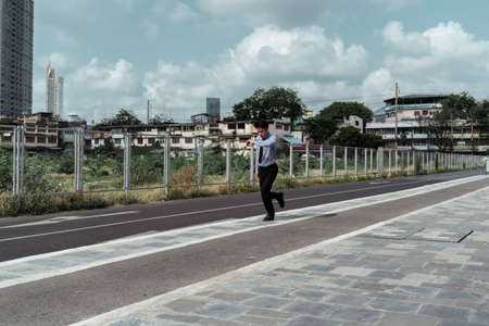 Business man running on track in daylight.の写真素材