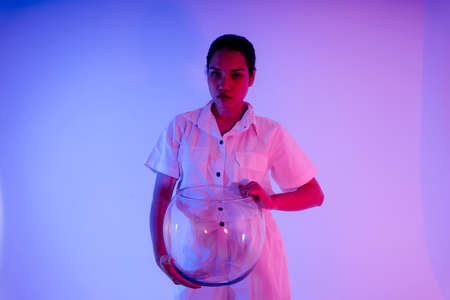 Portrait of asian woman astronaut with space helmet in neon light.の写真素材