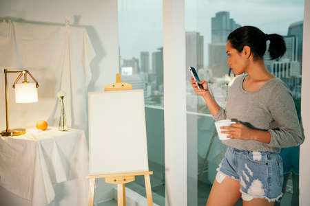 Asian female artist take a break looking for inspiration for artwork painting.の写真素材